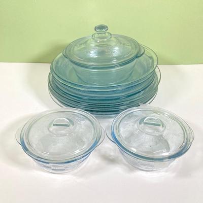 LOT 179: Large Fire King Oven Glass Collection - 2 Racks with Custard Cups, Plates, Small Lidded Bowls and Individual Custard Cups