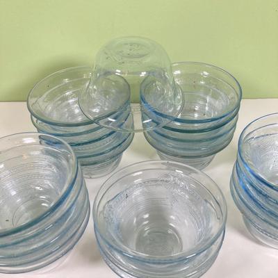 LOT 179: Large Fire King Oven Glass Collection - 2 Racks with Custard Cups, Plates, Small Lidded Bowls and Individual Custard Cups