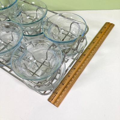 LOT 179: Large Fire King Oven Glass Collection - 2 Racks with Custard Cups, Plates, Small Lidded Bowls and Individual Custard Cups
