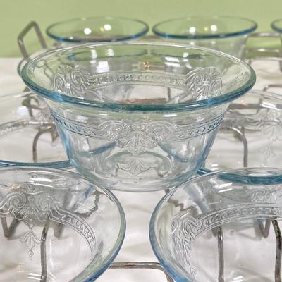 LOT 179: Large Fire King Oven Glass Collection - 2 Racks with Custard Cups, Plates, Small Lidded Bowls and Individual Custard Cups