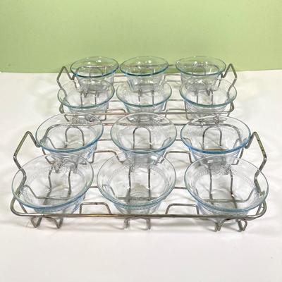 LOT 179: Large Fire King Oven Glass Collection - 2 Racks with Custard Cups, Plates, Small Lidded Bowls and Individual Custard Cups
