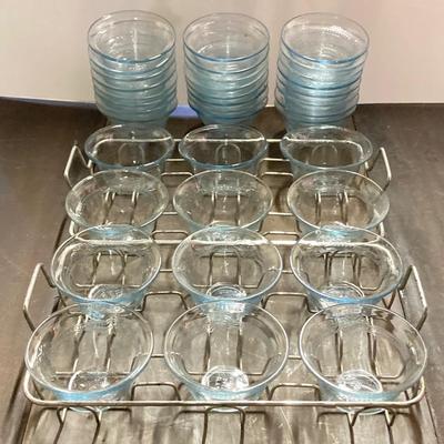 LOT 179: Large Fire King Oven Glass Collection - 2 Racks with Custard Cups, Plates, Small Lidded Bowls and Individual Custard Cups