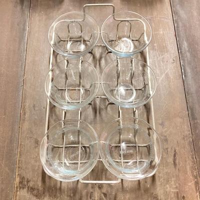 LOT 179: Large Fire King Oven Glass Collection - 2 Racks with Custard Cups, Plates, Small Lidded Bowls and Individual Custard Cups