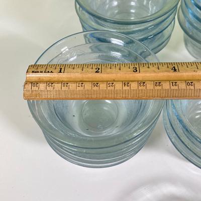 LOT 179: Large Fire King Oven Glass Collection - 2 Racks with Custard Cups, Plates, Small Lidded Bowls and Individual Custard Cups