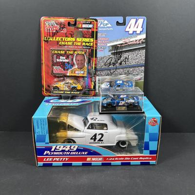 LOT 262: NASCAR Collectibles: Signed Ken Schrader & Buckshot Jones Die Cast Cars NIP, Lee Petty NIP 1949 Plymouth Die Cast