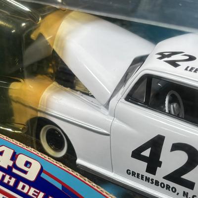 LOT 262: NASCAR Collectibles: Signed Ken Schrader & Buckshot Jones Die Cast Cars NIP, Lee Petty NIP 1949 Plymouth Die Cast