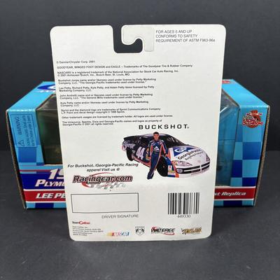LOT 262: NASCAR Collectibles: Signed Ken Schrader & Buckshot Jones Die Cast Cars NIP, Lee Petty NIP 1949 Plymouth Die Cast