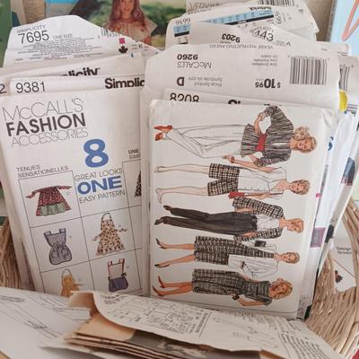 AN ASSORTMENT OF SEWING PATTERNS AND INSTRUCTION BOOKS