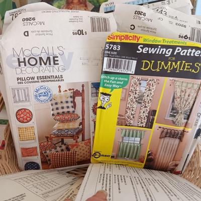 AN ASSORTMENT OF SEWING PATTERNS AND INSTRUCTION BOOKS