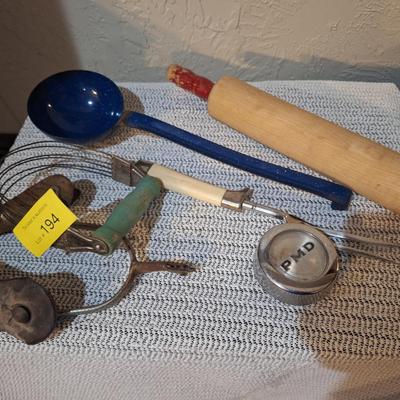 Sale Photo Thumbnail #533: a single spur, the center of a hub cap and a few random kitchen items.