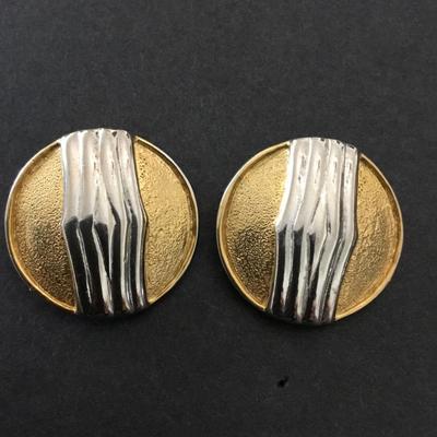 Vintage made in the USA silver and gold toned circular clip on earrings. Very nice.