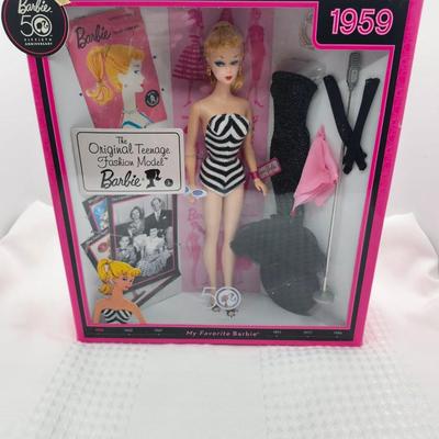 Sale Photo Thumbnail #400: Reproduction, released in 2008     celebration of 50th anniversary
Classic black and white swimsuit, solo in the spotlight black evening gown w accessories 
New in box, sealed 
Retail $84 to $105