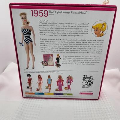 Sale Photo Thumbnail #399: Reproduction, released in 2008     celebration of 50th anniversary
Classic black and white swimsuit, solo in the spotlight black evening gown w accessories 
New in box, sealed 
Retail $84 to $105