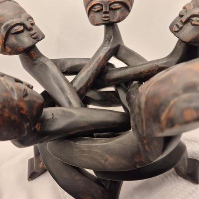 Sale Photo Thumbnail #435: Very unique carved table, from 1 piece of wood.
13 inches tall x 15 inches wide
In good condition
The figures move freely, up and down for possible table height changes 
Retail $200++