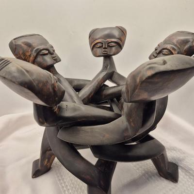 Sale Photo Thumbnail #436: Very unique carved table, from 1 piece of wood.
13 inches tall x 15 inches wide
In good condition
The figures move freely, up and down for possible table height changes 
Retail $200++