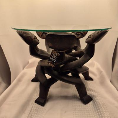 Sale Photo Thumbnail #432: Very unique carved table, from 1 piece of wood.
13 inches tall x 15 inches wide
In good condition
The figures move freely, up and down for possible table height changes 
Retail $200++