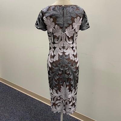 Sale Photo Thumbnail #447: Below Knee length, Gray and silver lace 
Back zip, cream lining
Kick pleat in back., polyester and metallic
Size 4 
Very good condition, 1 original owner
