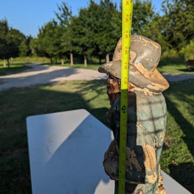 Sale Photo Thumbnail #184: approx 30 inches tall, he's got a card in his hat, he's reaching for a hidden gun and there is a knife hidden in a pocket.  He show a lot of wear from being outside but he is a fun statue to have.