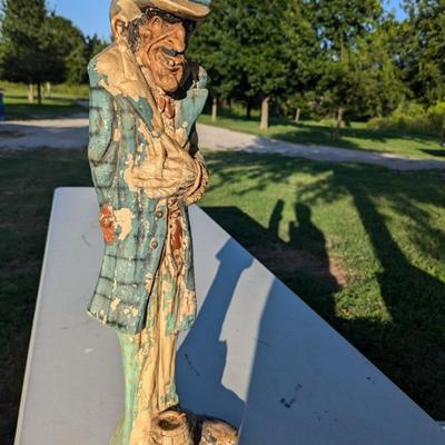 Sale Photo Thumbnail #180: approx 30 inches tall, he's got a card in his hat, he's reaching for a hidden gun and there is a knife hidden in a pocket.  He show a lot of wear from being outside but he is a fun statue to have.