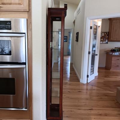 HOWARD MILLER LIGHTED NARROW CURIO CABINET WITH MIRRORED BACK