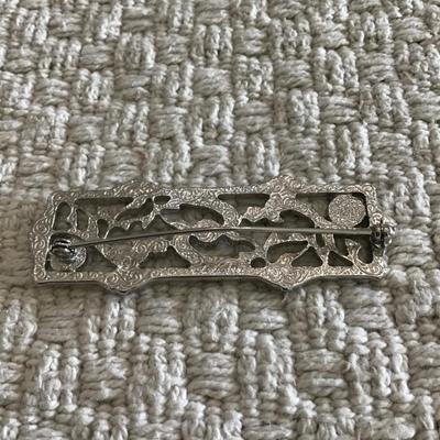 Large silver tone scroll brooch