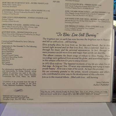 Sale Photo Thumbnail #103: The image you sent shows a vintage vinyl record album titled "To Elvis: Love Still Burning". 
Here's some information about this record:
Format and Content: It's a 12-inch picture disc LP featuring an image of Elvis Presley. The album is a tribute compila