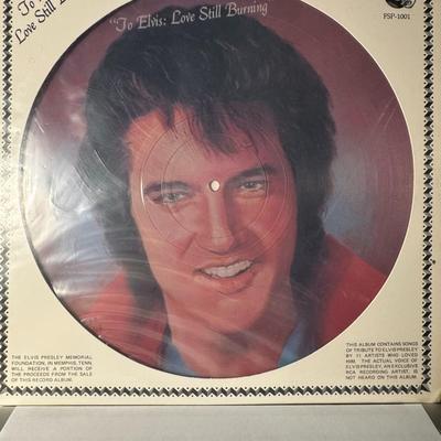 Sale Photo Thumbnail #102: The image you sent shows a vintage vinyl record album titled "To Elvis: Love Still Burning". 
Here's some information about this record:
Format and Content: It's a 12-inch picture disc LP featuring an image of Elvis Presley. The album is a tribute compila