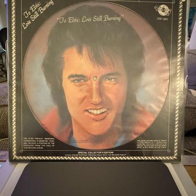 Sale Photo Thumbnail #94: The "To Elvis: Love Still Burning" LP picture disc is a vinyl record released in 1978 as a tribute to Elvis Presley. 
Here are details about this record:
The record features an image of Elvis Presley and is a tribute album with various artists performing 