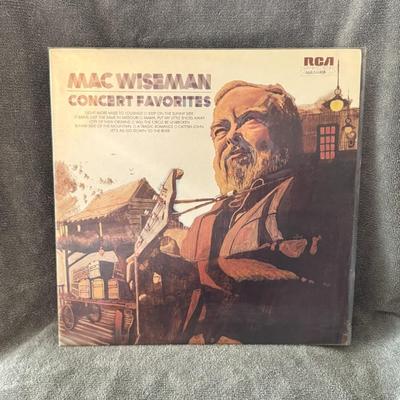 Sale Photo Thumbnail #318: "Concert Favorites" by Mac Wiseman, a country and bluegrass artist. This is a vinyl LP album released in 1973 by RCA Victor. 
Album Details:
Artist: Mac Wiseman
Title: Concert Favorites
Label: RCA Victor
Format: Vinyl LP, Album, Stereo
Release Year: 1973
