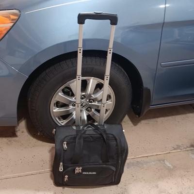 FOLDING DOLLY AND A CARRY-ON BAG WITH WHEELS