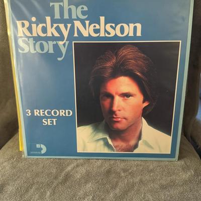 Sale Photo Thumbnail #416: The Ricky Nelson Story," a 3-record vinyl LP compilation set. 
Here's what you can know about it:
Artist: The compilation features the legendary American singer-songwriter and actor Ricky Nelson, known for his influential contributions to rock and roll an