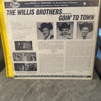 Sale Photo Thumbnail #425: "Goin' To Town" by The Willis Brothers. 
Additional information about the album and band includes:
Artist: The Willis Brothers were a country music group, known for their association with the Grand Ole Opry, as indicated on the album cover.
Album Title: T