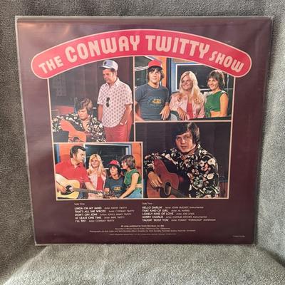 Sale Photo Thumbnail #261: "The Conway Twitty Show" released in 1975. 
Here's more about this album:
Artist: The album features Conway Twitty and other performers, notably his band known as "The Twitty Birds," and potentially members of his family, including his children.
Release D