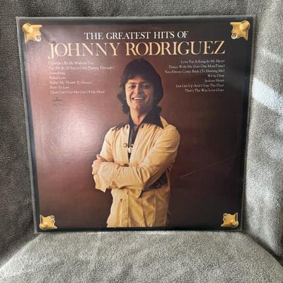 Sale Photo Thumbnail #438: "The Greatest Hits of Johnny Rodriguez". 
Here's information about this album:
Artist: Johnny Rodriguez, a country music singer.
Release Year: The album was originally released around 1975.
Record Label: Mercury Records.
Format: The image shows a 12-inch 
