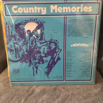 Sale Photo Thumbnail #227: "Country Memories". 
Here's what you might like to know about it:
Album Title: Country Memories.
Release Details: It's a country music compilation album, likely released by Columbia Records or CSP Columbia Records around 1973.
Cover Art: The album cover f