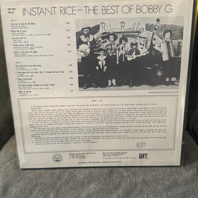 Sale Photo Thumbnail #447: "Instant Rice - The Best Of Bobby G." by American country music singer-songwriter Bobby G. Rice. 
Here is more information about the album and artist:
Artist: Bobby G. Rice, a country music singer-songwriter known for hits in the 1970s and 80s.
Album Titl