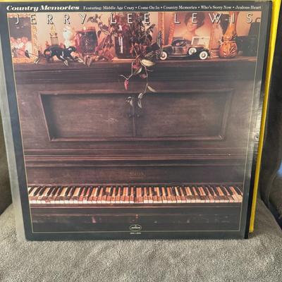 Sale Photo Thumbnail #256: Jerry Lee Lewis, the legendary American singer, songwriter, and pianist, often referred to as "The Killer".
Album Title: Country Memories.
Release Information: It is a studio album released in 1977 on Mercury Records.
Genre: Primarily country, reflecting 