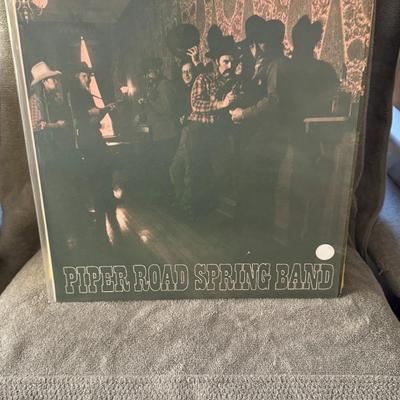 Sale Photo Thumbnail #274: Piper Road Spring Band. 
This is likely the band's debut album, originally released in 1976 on the Fiends Club label (catalog number PRSB 6357). The band is known for their blend of bluegrass, folk, country, and even some jazz influences. Reviews praise t
