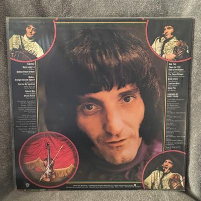 Sale Photo Thumbnail #321: Alive & Pickin' by Doug Kershaw. 
Here's some information about the album:
Artist: Doug Kershaw, a renowned Cajun fiddler and musician.
Album Title: Alive & Pickin'.
Release Year: 1975.
Label: Warner Bros. Records.
Format: 12" Vinyl LP (Long Play) record.
