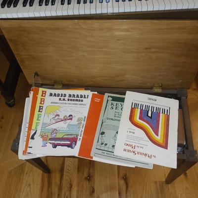 BALDWIN PIANO WITH BENCH AND SHEET MUSIC