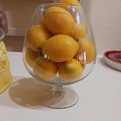 AN UNIQUE COOKIE JAR AND A GLASS BOWL OF FAUX LEMONS