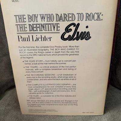 Sale Photo Thumbnail #497: "The Boy Who Dared to Rock: The Definitive Elvis" by Paul Lichter. 
This book is a biography of Elvis Presley and is known for its extensive coverage of his recording sessions, record covers from around the world (including rare and bootleg albums), and l