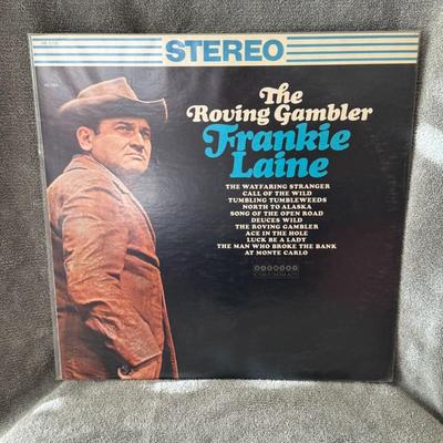 Sale Photo Thumbnail #470: "The Roving Gambler" by Frankie Laine. 
Here's more information about the album:
Artist: Frankie Laine, a renowned American singer known for his powerful voice and diverse musical styles, including pop, jazz, and country.
Album Title: The Roving Gambler.
