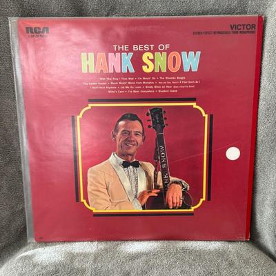 Sale Photo Thumbnail #332: Hank Snow, a Canadian-American country music artist. 
Key details:
Artist: Hank Snow, a country music figure known as "The Singing Ranger".
Title: The Best of Hank Snow.
Format: Vinyl LP. The size and the record player speed of 33rpm, mentioned in descrip
