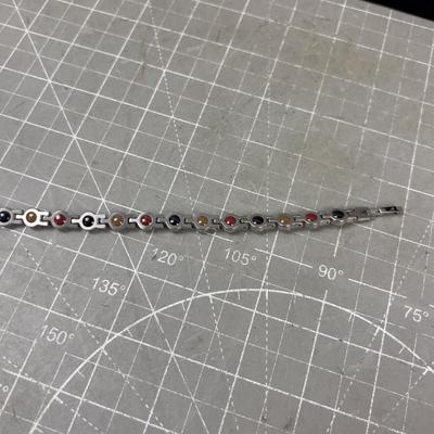 Sale Photo Thumbnail #314: Interesting. Nice. Has Colored stone on one size and faux diamond on the other. 