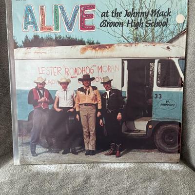 Sale Photo Thumbnail #272: "Alive at the Johnny Mack Brown High School" by Lester "Roadhog" Moran & The Cadillac Cowboys.
Here's more about this unique album:
Artist & Concept: This is actually a comedy album by the renowned country music group, The Statler Brothers, performing und