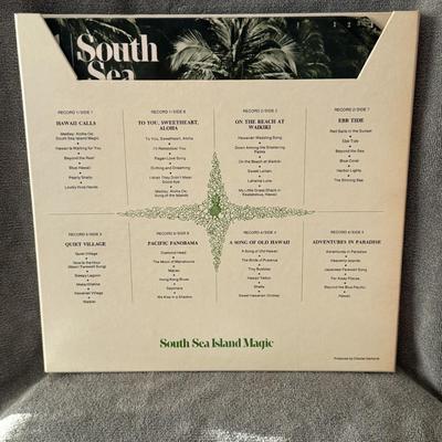 Sale Photo Thumbnail #353: "South Sea Island Magic" 4-LP vinyl record box set, released in 1968 by Reader's Digest. 
Here's some information about this vintage album:
Content: It is a compilation featuring various artists performing Hawaiian and South Sea-themed music, offering a n
