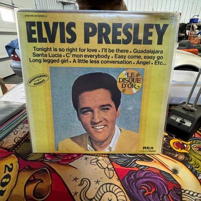 Sale Photo Thumbnail #115: Elvis Presley titled "Le Disque D'Or" (The Gold Record). 
More details about the album:
Format and Origin: This is a vinyl LP record from RCA Impact, and the version shown is a French import.
Tracklist Highlights: The album cover lists several Elvis hits,