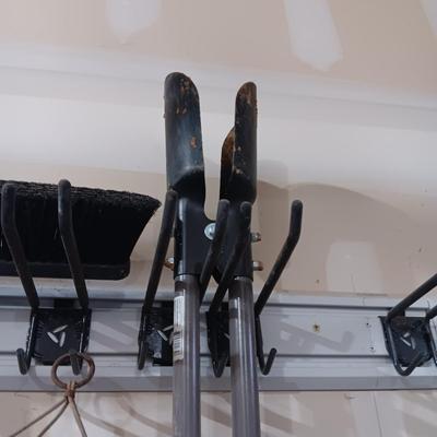 LARGE WIND CHIME, PUSH BROOM, SNOW SHOVEL, POST HOLE DIGGER, SHOVEL AND SOME ICE MELT