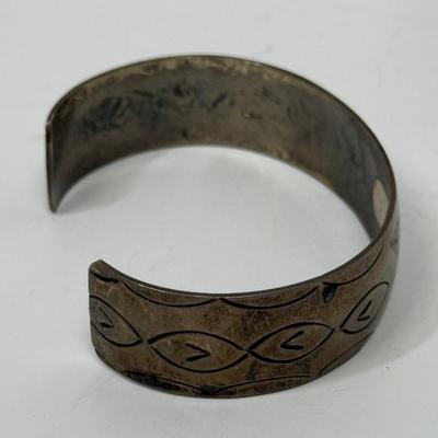 Sale Photo Thumbnail #501: Bracelet has markings inside that are faint and could not be identified, but the bracelet has the look and feel of a vintage silver bracelet.